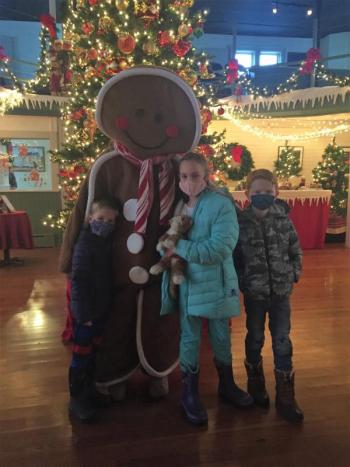 Roger and Jane Gifford share a Kodak moment with Leif Carlson-Nelson. How often do you get the chance to take a photo with a live gingerbread? LISA KRISTOFF/Boothbay Register