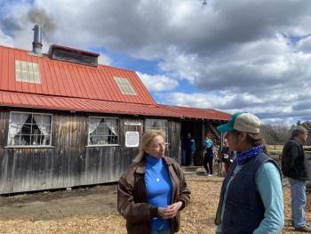 Gov. Janet Mills and owner Jan Goranson talk outside the Goranson Farm sugarhouse March 27. Courtesy photo