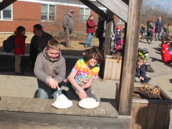 Sixth graders Jackson Zehm, left, and Ethan Clark fill pie tins with whipped cream in preparation for putting a pie in the face of their teacher and principal. BILL PEARSON/Boothbay Register