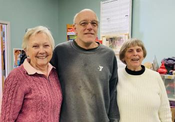 Back room heavy lifter Richard Teague pauses for a moment with volunteers Sue Hochstein, left, and Judy Boyes. Courtesy of St. Andrews Auxiliary