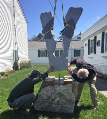 Joseph DiMauro and Bill Royall check to ensure the Maine granite sculpture is in the proper position for landing. LISA KRISTOFF/Boothbay Register