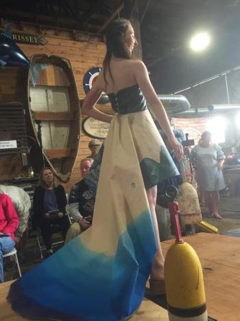 The Interns from Coastal Maine Botanical Gardens’ design of sail cloth, tarps, a fisherman's jacket and waders, netting, and fishing line. Model: Lara Beckius