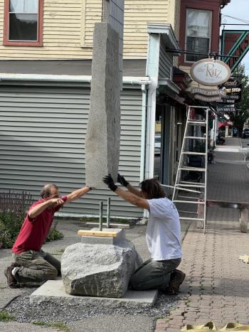 Mark Herrington, left, is assisted by Joseph DiMauro with installing his 14-foot “Lifting Fog” sculpture. Patricia Royall photo
