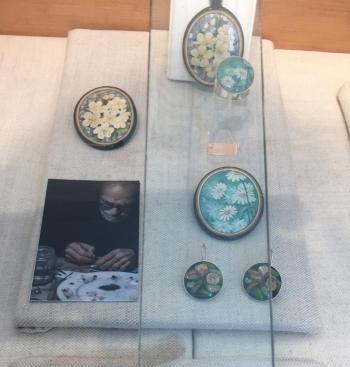 Miniature floral paintings by Firenze, Italy artist in jewelry at Gold/Smith Gallery. LISA KRISTOFF/Boothbay Register