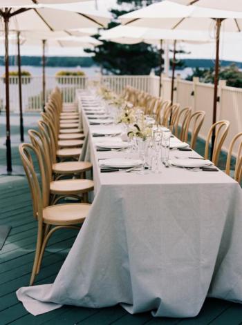Wedding seating for a reception on the deck at Spruce Point Inn. Tracy Burch Photography