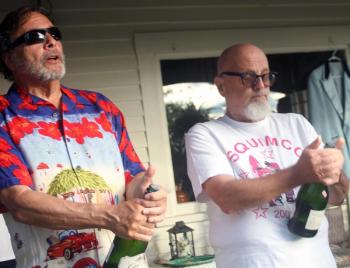 Guitarist John Wells, left, and band leader and bass player Ken Steiner pop the corks in celebration of Hennessy’s 100th. STEVE EDWARDS/Boothbay Register