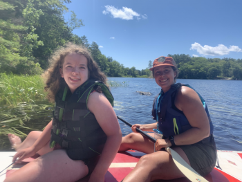 Camper Chloe Joneth of Boothbay and Deputy Director Jess Donohoe on Knickerbocker Lake. Courtesy of Hearty Roots