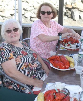Two lobsters, corn and clams for Suzanne Raudenbush, left, and Emma Benner, STEVE EDWARDS/Boothbay Register