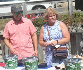 Bob and Janice Cotier look over the silent auction offerings. STEVE EDWARDS/Boothbay Register