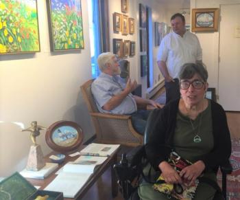 Artist Andrea Peters, forefront, at the opening reception for her new show at Gleason. Behind her on the left are her husband, Mark Peters, and Andrew Gleason. LISA KRISTOFF/Boothbay Register