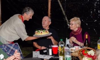 Preservation Party co-chair Ann Light demonstrates a cake to Neil and Cathy Lamb during Lincoln County Historical Association’s annual auction of cakes and experiences. Photo by Bob Bond