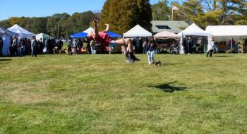 Fireman E3 Raymond Mellett stationed at the USCG in West Boothbay Harbor turned acrobat along with members of his family at the Fall Foilage Festival at Boothbay Railway Village Oct. 8. LISA KRISTOFF/Boothbay Register