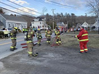 Edrick Larkin, right, of Southport Fire Department talks to the firefighters who first responded to the scene. KEVIN BURNHAM/Boothbay Register