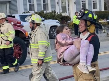 The “victim,” Sheyenne Upham, gets carried away from the house to the BRAS attendants. KEVIN BURNHAM/Boothbay Register