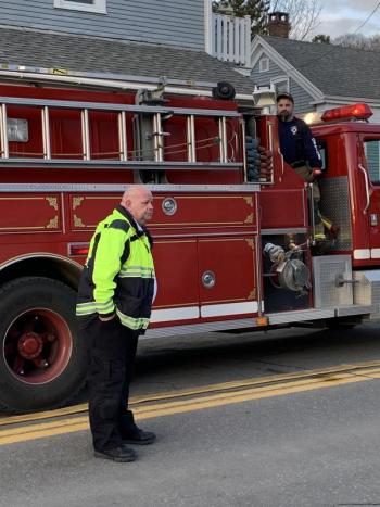 Boothbay Region Ambulance Service EMS Chief Dan Gardner watches the training as Boothbay firefighter David Steinmetz mans the truck. KEVIN BURNHAM/Boothbay Register