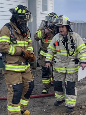 Boothbay Harbor Assistant Fire Chief Glenn Tilton, right, helps a couple of firefighters. KEVIN BURNHAM/Boothbay Register