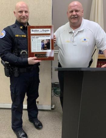 Boothbay Region Ambulance Service EMS Chief Dan Gardner, right, congratulates Boothbay Harbor Police Chief Doug Snyder March 13 for his promotion. BILL PEARSON/Boothbay Register