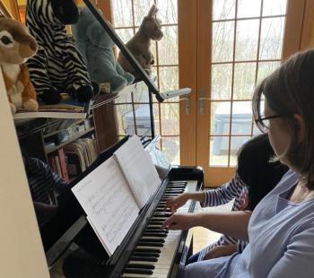 Anne Barker teaches her granddaughter Lucia Flores piano using Barker’s new Piano Safari method. Kjirsten Barker photo