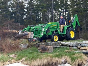 Mike Wallace grabs another piece of driftwood for the Southport Community Project. Courtesy photo