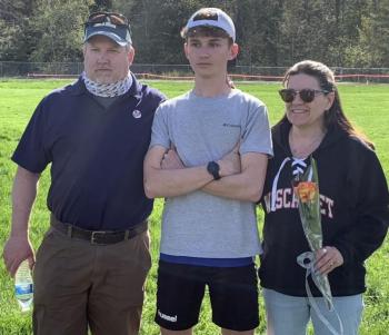 Peyton Bladgon and his parents Michael and Michelle Blagdon were honored May 9 during the Senior Night ceremony for the Boothbay/Wiscasset Boys’ Track and Field team. BILL PEARSON/Boothbay Register