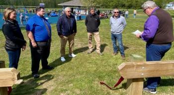 Boothbay Baptist minister Glen Carter, right, leads a prayer May 26 prior to the ribbon-cutting ceremony for the new baseball field. Michelle Amero photo