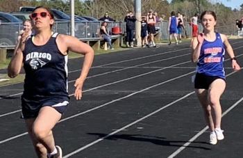 Boothbay/Wiscasset runner Makaya Hodson, right, makes her move in a Mountain Valley Conference race May 9 in Wiscasset. BILL PEARSON/Boothbay Register