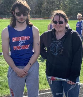 Boothbay/Wiscasset track team senior Bryan Gagnon presented his mother, Ashley Gagnon, with a flower prior to the final Mountain Valley Conference home meet. BILL PEARSON/Boothbay Register