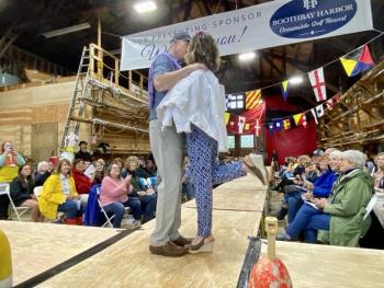 Julie and Paul Roberts from the House of Logan share a kiss on the runway. ISABELLE CURTIS/Boothbay Register