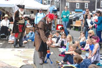 Captain Carver tells the story of “Treasure Island” while Bloody Spike Pierce operates puppet Jim Hawkins for the crowd June 27. FRITZ FREUDENBERGER/Boothbay Register