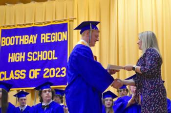 Kayden Ames receives one of his awards from Leanne Burnham. FRITZ FREUDENBERGER/Boothbay Register