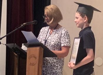 Teacher Jennifer Gosselin presents John Cooper with the Sara Leone Citizenship Award during the June 22 graduation ceremony. BILL PEARSON/Boothbay Register