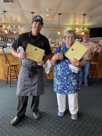 Kelly Farrin, People’s Choice Winner, and Tancy Mitchell, Judge’s Choice Winner, pose with gift certificates. Courtesy of Stephanie Branch