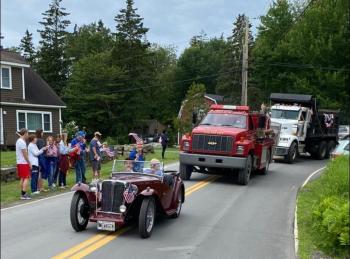 The Meserves’ MG and some town trucks. Courtesy of Helen Meserve