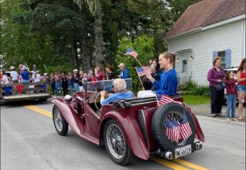 Ham Meserve in his MG and his grandkids roll past the onlookers at the Southport Island Association’s July 4 parade. Courtesy of Helen Meserve