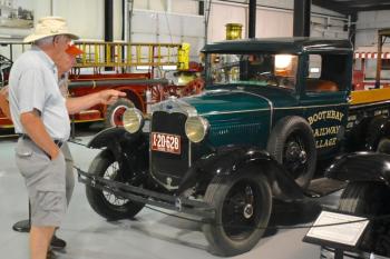 Visitors step out of the misty weather to enjoy the Antique Automobile Museum at the Railway Village. FRITZ FREUDENBERGER/Boothbay Register
