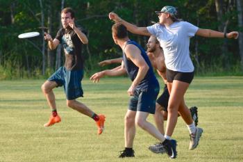 Players hustle for the flying disk during the July 13 Ultimate Frisbee game at Clifford Park in Boothbay. FRITZ FREUDENBERGER/Boothbay Register