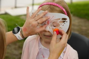 Hadley Hakanson gets her face painted by Sabryna Fairfield. Michael Leonard photo