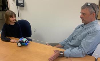 Lyla Joyce shows her father, Bill Joyce, how the robot works which she built last month at the National Youth Leadership Forum held in Waltham, Massachusetts. BILL PEARSON/Boothbay Register