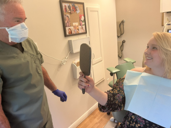 Dr. David Pier of Mount Pleasant Dental Care in West Rockport with Samantha Hunt. Hunt is taking her first look at the smile that Dr. Pier and his staff restored for her for free through “Finding Our Smiles.” Patrisha McLean photo