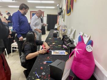 Visitors peruse raffle prizes donated by local merchants. ISABELLE CURTIS/Boothbay Register