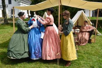 Carolyn Lawson, left, leads a talk on women’s fashion with other civilian volunteers. FRITZ FREUDENBERGER/Boothbay Register
