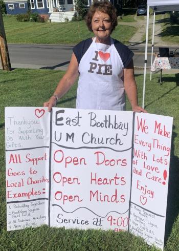 Sara Kerr displays a message board Aug. 12 showing bake sale customers the charities that benefit from the East Boothbay United Methodist Women’s bake sale. BILL PEARSON/Boothbay Register