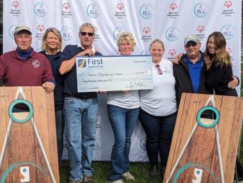 Members of the Boothbay Classic Cornhole team hold a mock check for Special Olympics Maine. CANDI JONETH/Boothbay Register