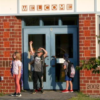 A student waves to a friend on the first day of school. FRITZ FREUDENBERGER/Boothbay Register
