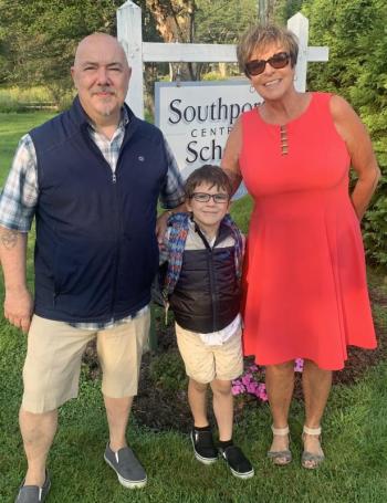Principal Lisa Clarke greets one of her second grade students, Aiden Nunan, and his father, John Nunan, Sept. 5 prior to Southport Central School’s first day of school. BILL PEARSON/Boothbay Register