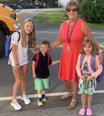 Principal Lisa Clarke greets students, from left, Mabel Kaler, Angus Kaler and Cairine Blackman Moorehouse on the first day of school in Southport. BILL PEARSON/Boothbay Register