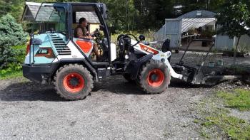 Dennis Spies moves trees at Conley’s in preparation for hurricane Lee. JANE CARPENTER/Boothbay Register