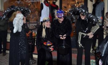 Adele and Andy of Slick’s, and company, watch as the trick or treaters approach during a Halloween Walk past. File photo