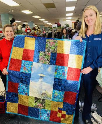 Melissa Brown, LincolnHealth Nurse Mgr. Oncology & Infusion services, right, accepts delivery of 20 quilts and dozens of infusion cushions handcrafted by St. Andrews Auxiliary Sewing Group for patients undergoing chemotherapy. Auxiliary cashier, Mary Pierce is on hand to train a new cashier. Displayed ‘Lighthouse’ quilt by Ann Hedgcock.Courtesy photo
