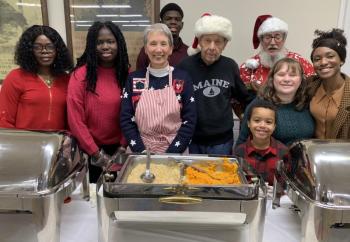 These Community Christmas Dinner servers shared their love for the community by serving a delicious meal Dec. 25 at the American Legion Hall in Boothbay. Pictured: front, Ezra Bates; second row: from right, Evenine Paultre, Jamie House, Bob Pascal, Jan Morton, Karis Louis, and Frances Louis; back row: from right, Big Al Cohen and Richardo Louis. BILL PEARSON/Boothbay Register